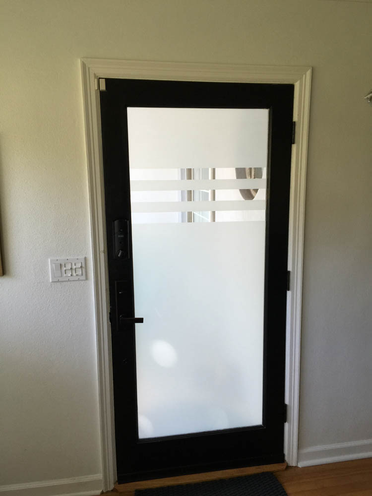 A glass door with a wooden frame